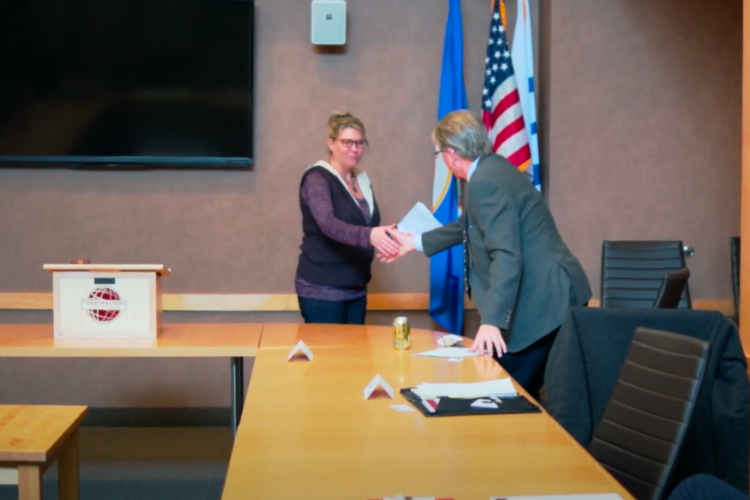 two people shaking hands at Toastmasters meeting