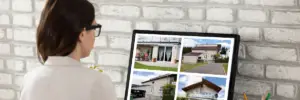 photo of woman looking at houses on a computer