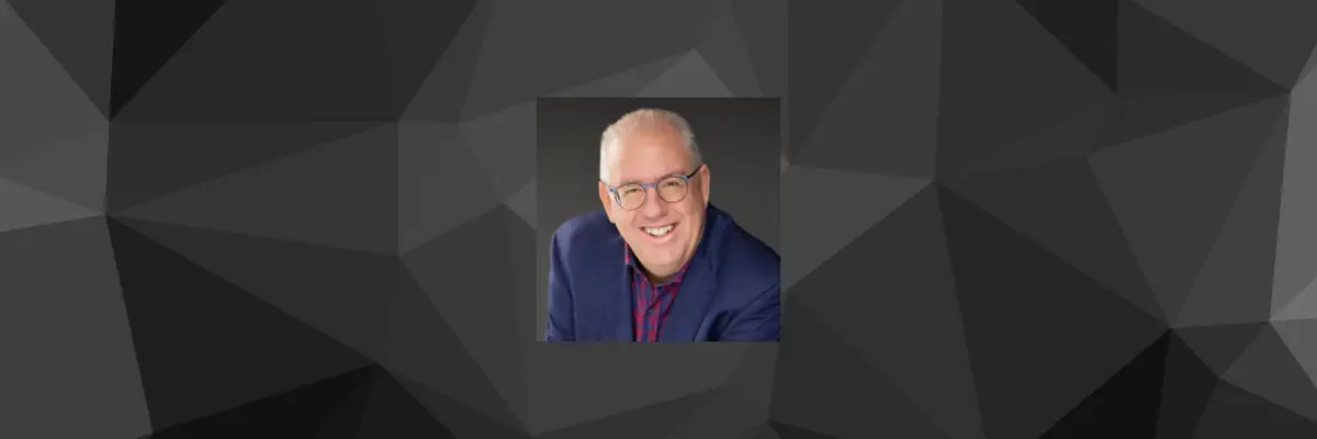 a man wearing glasses and a blue suit